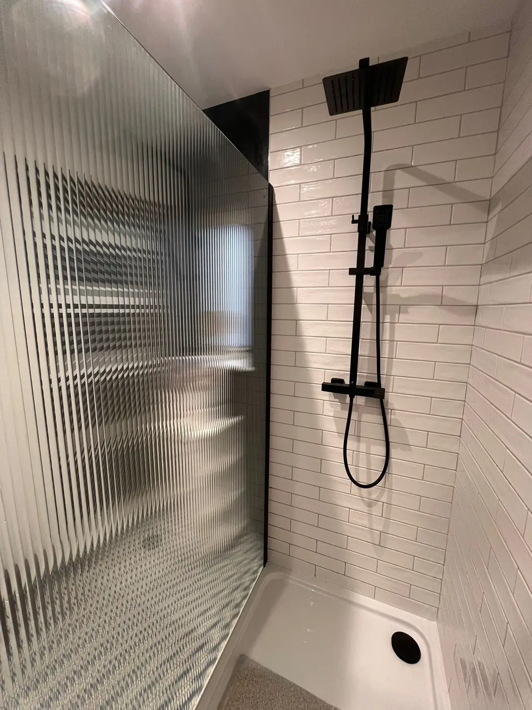 Reeded decorative film on a shower screen